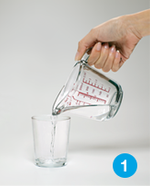2 ounces of water measured into a cup